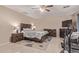 Main bedroom with ensuite bathroom, ceiling fan and tile floors at 6925 W Maldonado Rd, Laveen, AZ 85339