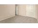 Bedroom with carpet, closet with white paneled doors and an open door at 6970 W Paso Trl, Peoria, AZ 85383