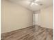 Spacious bedroom with hard surface flooring, ceiling fan, and entrance to bathroom at 6970 W Paso Trl, Peoria, AZ 85383