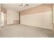 Spacious bedroom features neutral carpet and ceiling fan for a comfortable ambiance at 6970 W Paso Trl, Peoria, AZ 85383