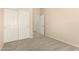 Bedroom with carpet, closet with white paneled doors and an open door to another room at 6970 W Paso Trl, Peoria, AZ 85383