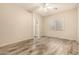 Bright bedroom with stylish flooring, ceiling fan, and access to bath at 6970 W Paso Trl, Peoria, AZ 85383