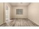 Spacious bedroom with neutral paint, stylish flooring, and a window at 6970 W Paso Trl, Peoria, AZ 85383