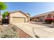 Charming single-story home featuring a two-car garage and low maintenance desert landscaping at 6970 W Paso Trl, Peoria, AZ 85383