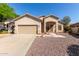 Charming single-story home featuring a two-car garage and low maintenance desert landscaping at 6970 W Paso Trl, Peoria, AZ 85383