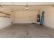 Spacious garage with concrete floor, overhead lighting, and built-in shelving at 6970 W Paso Trl, Peoria, AZ 85383