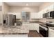 Bright kitchen boasts granite counters, stainless appliances, and white cabinets at 6970 W Paso Trl, Peoria, AZ 85383