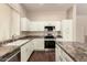 Well-lit kitchen has stainless appliances, stone countertops, and ample cabinet space at 6970 W Paso Trl, Peoria, AZ 85383