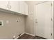 Laundry room with overhead cabinets and a door to the exterior at 6970 W Paso Trl, Peoria, AZ 85383