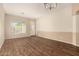 Bright living room boasts stylish wood floors and a sunny window at 6970 W Paso Trl, Peoria, AZ 85383
