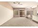 Spacious living area featuring a sliding glass door and carpet floors at 6970 W Paso Trl, Peoria, AZ 85383