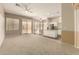 Spacious living area featuring a sliding glass door and carpet floors at 6970 W Paso Trl, Peoria, AZ 85383