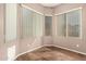 Bright office with multiple windows, blinds, and wood floor at 6970 W Paso Trl, Peoria, AZ 85383