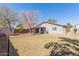 Expansive backyard with mature trees offering shade, and a storage shed at 7359 W Rancho Dr, Glendale, AZ 85303