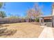A large, enclosed backyard features a covered patio and potential for landscaping at 7359 W Rancho Dr, Glendale, AZ 85303
