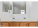 Close-up of the bathroom vanity with double sinks and large mirrors at 7359 W Rancho Dr, Glendale, AZ 85303