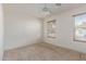 Bedroom featuring a ceiling fan and two windows at 7359 W Rancho Dr, Glendale, AZ 85303