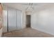 Bedroom featuring a ceiling fan and a closet with sliding doors at 7359 W Rancho Dr, Glendale, AZ 85303