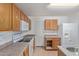 Neutral toned kitchen featuring tiled floors, white appliances, and lots of storage at 7359 W Rancho Dr, Glendale, AZ 85303