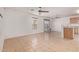 Open-concept living space with tiled floors, natural light, and a ceiling fan at 7359 W Rancho Dr, Glendale, AZ 85303