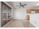 View of the open-concept living space with tiled floors, natural light, and a ceiling fan at 7359 W Rancho Dr, Glendale, AZ 85303