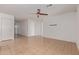 Open-concept living space with tiled floors, natural light, and a ceiling fan at 7359 W Rancho Dr, Glendale, AZ 85303