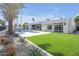 Expansive backyard features lush landscaping, a sparkling pool, an outdoor kitchen, and manicured plants at 7939 E Via Linda --, Scottsdale, AZ 85258