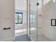Modern bathroom with glass shower door and view to the bedroom and outdoor pool area at 7939 E Via Linda --, Scottsdale, AZ 85258