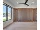 Modern bedroom featuring a stylish wood accent wall, a ceiling fan, recessed lighting and large windows at 7939 E Via Linda --, Scottsdale, AZ 85258