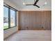Modern bedroom featuring a stylish wood accent wall, a ceiling fan, recessed lighting and large windows at 7939 E Via Linda --, Scottsdale, AZ 85258