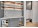 Butler's pantry features custom cabinets, stone countertop and built-in dual wine refrigerators at 7939 E Via Linda --, Scottsdale, AZ 85258