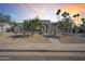 Modern home featuring a xeriscaped yard, a sleek stone accent wall, and a black framed glass front door at 7939 E Via Linda --, Scottsdale, AZ 85258