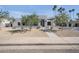 Modern home featuring a xeriscaped yard, a sleek stone accent wall, and a black framed glass front door at 7939 E Via Linda --, Scottsdale, AZ 85258