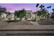 Contemporary home with illuminated landscape, complementing the sleek architecture at dusk at 7939 E Via Linda --, Scottsdale, AZ 85258