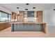 Modern kitchen boasts a large waterfall island, custom cabinets, and stainless appliances at 7939 E Via Linda --, Scottsdale, AZ 85258