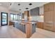 Spacious kitchen with a large waterfall island, custom cabinetry, stainless steel appliances, and light wood flooring at 7939 E Via Linda --, Scottsdale, AZ 85258