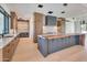 Bright kitchen featuring custom cabinets, a large island, a stylish backsplash, and modern light fixtures at 7939 E Via Linda --, Scottsdale, AZ 85258