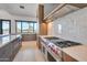 Gourmet kitchen with a stainless steel oven range, custom cabinets, marble backsplash, and eat in bar at 7939 E Via Linda --, Scottsdale, AZ 85258