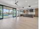 Open concept living room showcasing the kitchen, a large sliding glass door to the pool and light wood flooring at 7939 E Via Linda --, Scottsdale, AZ 85258