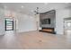 Bright living room with a modern fireplace, large television, and light hardwood floors at 7939 E Via Linda --, Scottsdale, AZ 85258