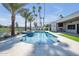Beautiful pool area with a spa, lush landscaping, travertine decking, and outdoor kitchen at 7939 E Via Linda --, Scottsdale, AZ 85258