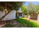 View of the backyard with mature trees and access to the home's covered patio at 902 W Glendale Ave # 115, Phoenix, AZ 85021