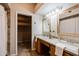 Bright bathroom with double sinks, mirrors, and adjacent walk-in closet at 902 W Glendale Ave # 115, Phoenix, AZ 85021