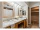 Bathroom featuring a double vanity, decorative mirrors, and a makeup counter with a stool at 902 W Glendale Ave # 115, Phoenix, AZ 85021