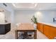 View of the dining room showing the table and chairs as well as built in wood cabinets for storage at 902 W Glendale Ave # 115, Phoenix, AZ 85021