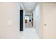 Condo hallway with tile flooring and view of living area at 902 W Glendale Ave # 115, Phoenix, AZ 85021