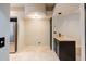 Another view showing the kitchen refrigerator and adjacent countertops with black cabinetry at 902 W Glendale Ave # 115, Phoenix, AZ 85021