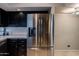 Stainless steel French door refrigerator with a water and ice dispenser complements the cabinetry and countertops at 902 W Glendale Ave # 115, Phoenix, AZ 85021