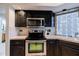 Updated kitchen features stainless steel appliances, black cabinetry, and light countertops and backsplash at 902 W Glendale Ave # 115, Phoenix, AZ 85021