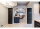 View of the dining room through the open layout, with black kitchen cabinets on either side of the opening at 902 W Glendale Ave # 115, Phoenix, AZ 85021